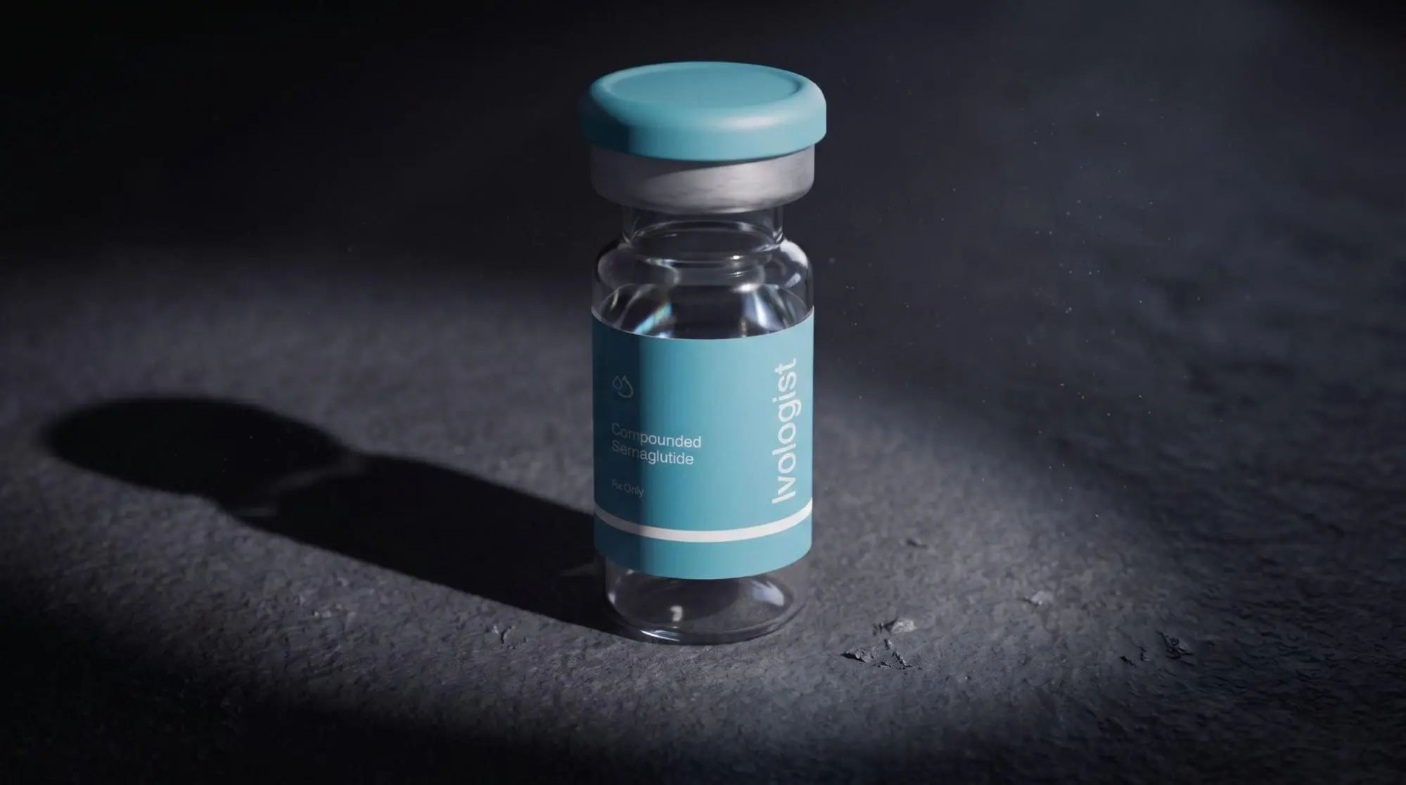 Close-up of a compounded semaglutide vial on a dark surface under dramatic lighting