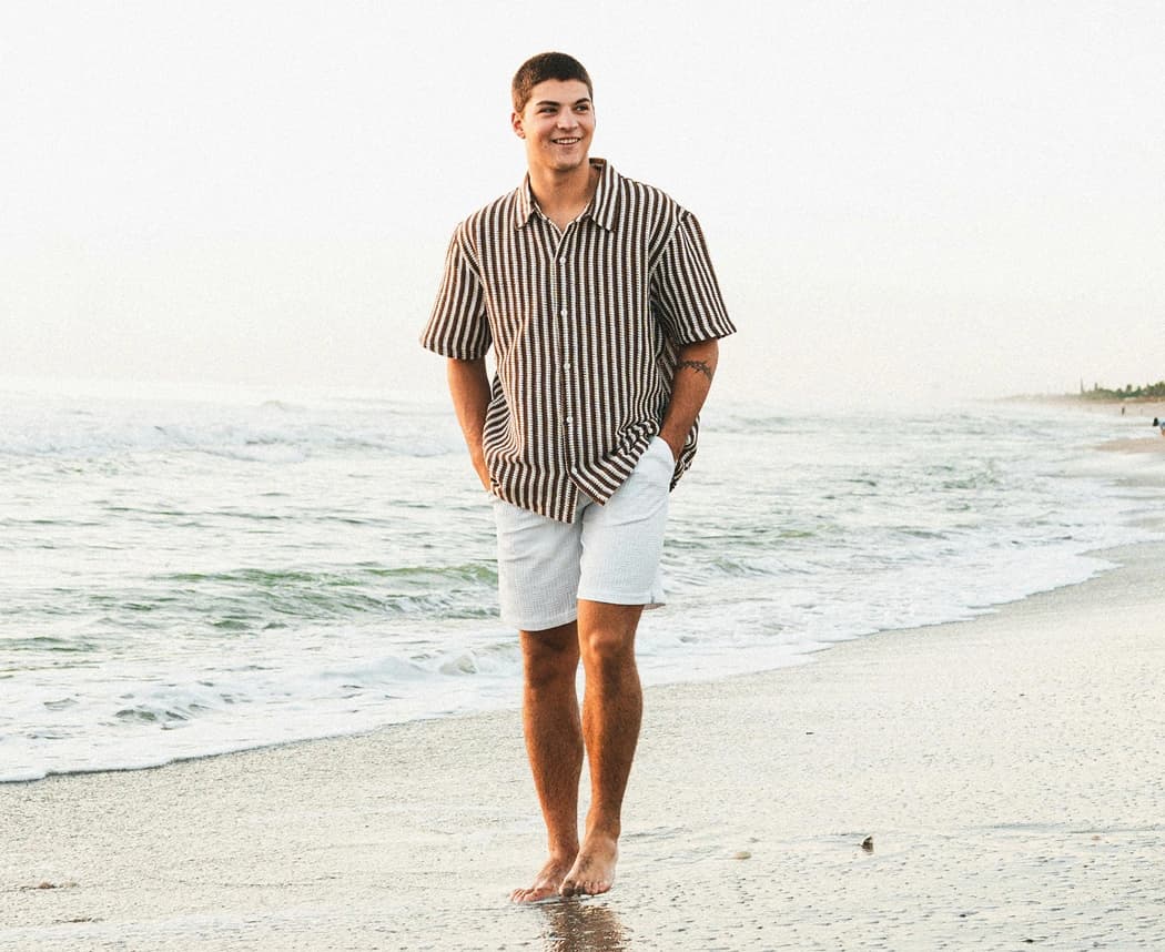 Man walking relaxed along the shoreline