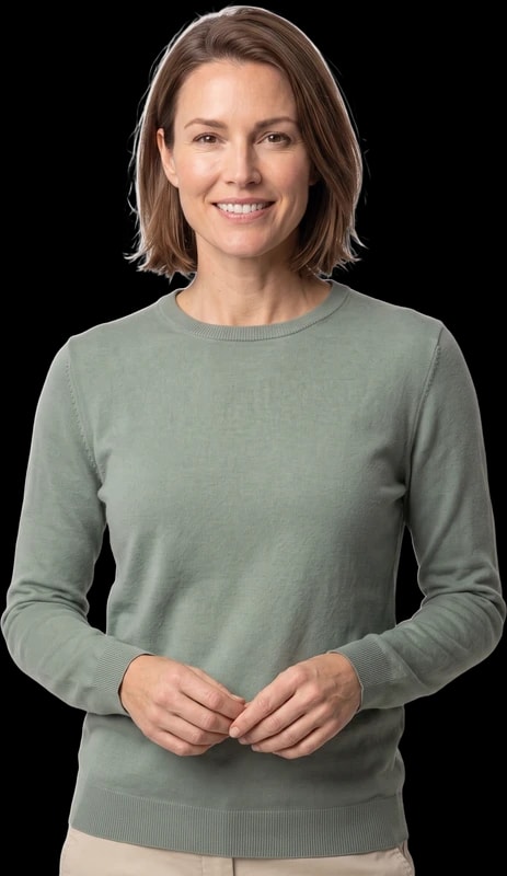Woman in a sage sweater smiling with her hands clasped