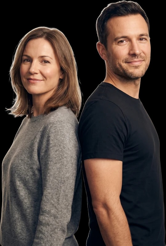 Man and woman standing back to back, smiling