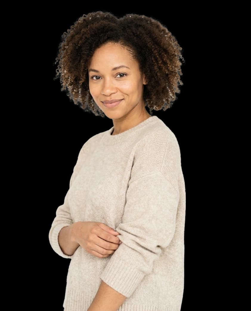 Woman in beige sweater smiling, representing wellness and confidence