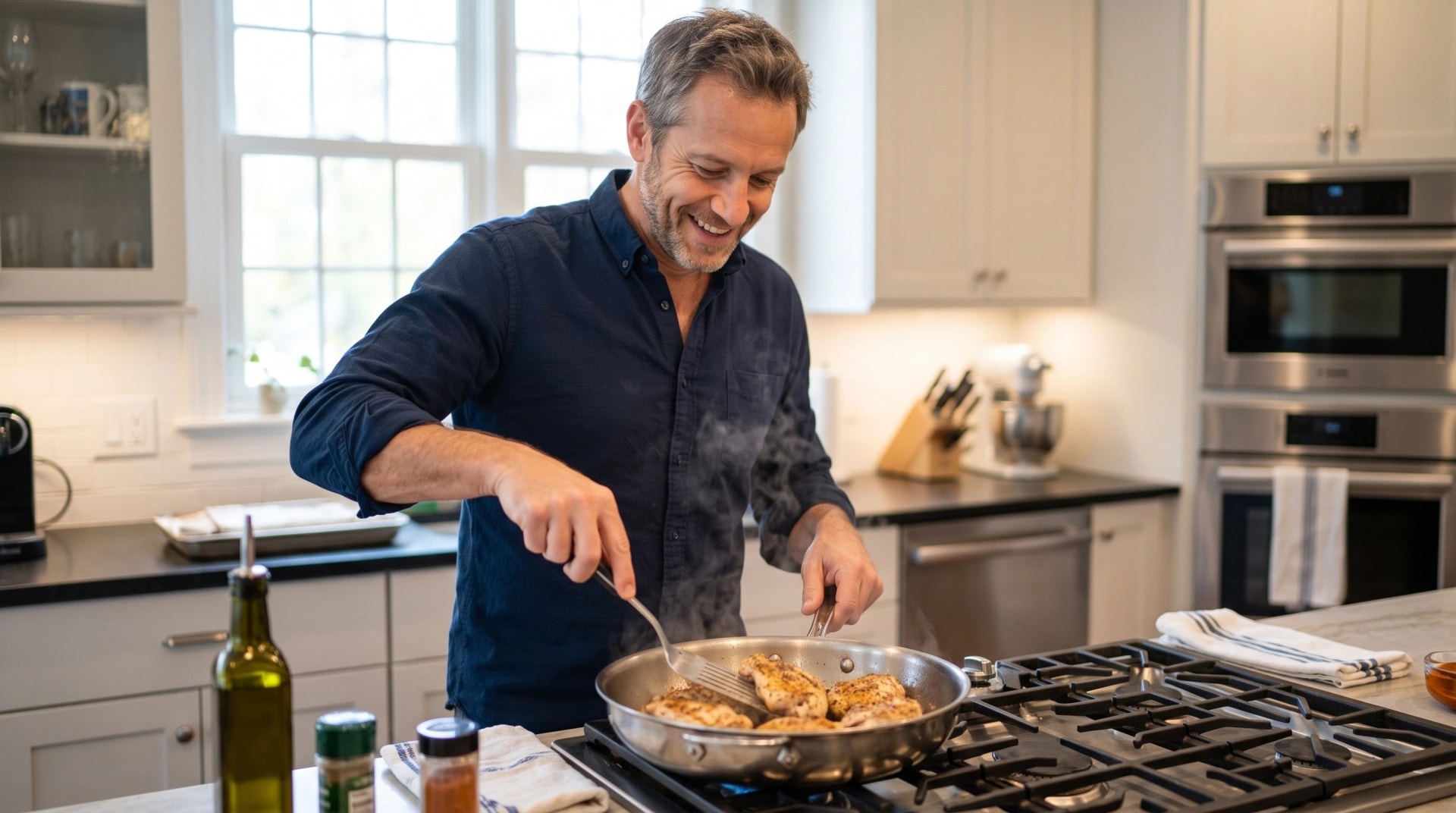 A man cooking chicken in a skillet at his kitchen stove