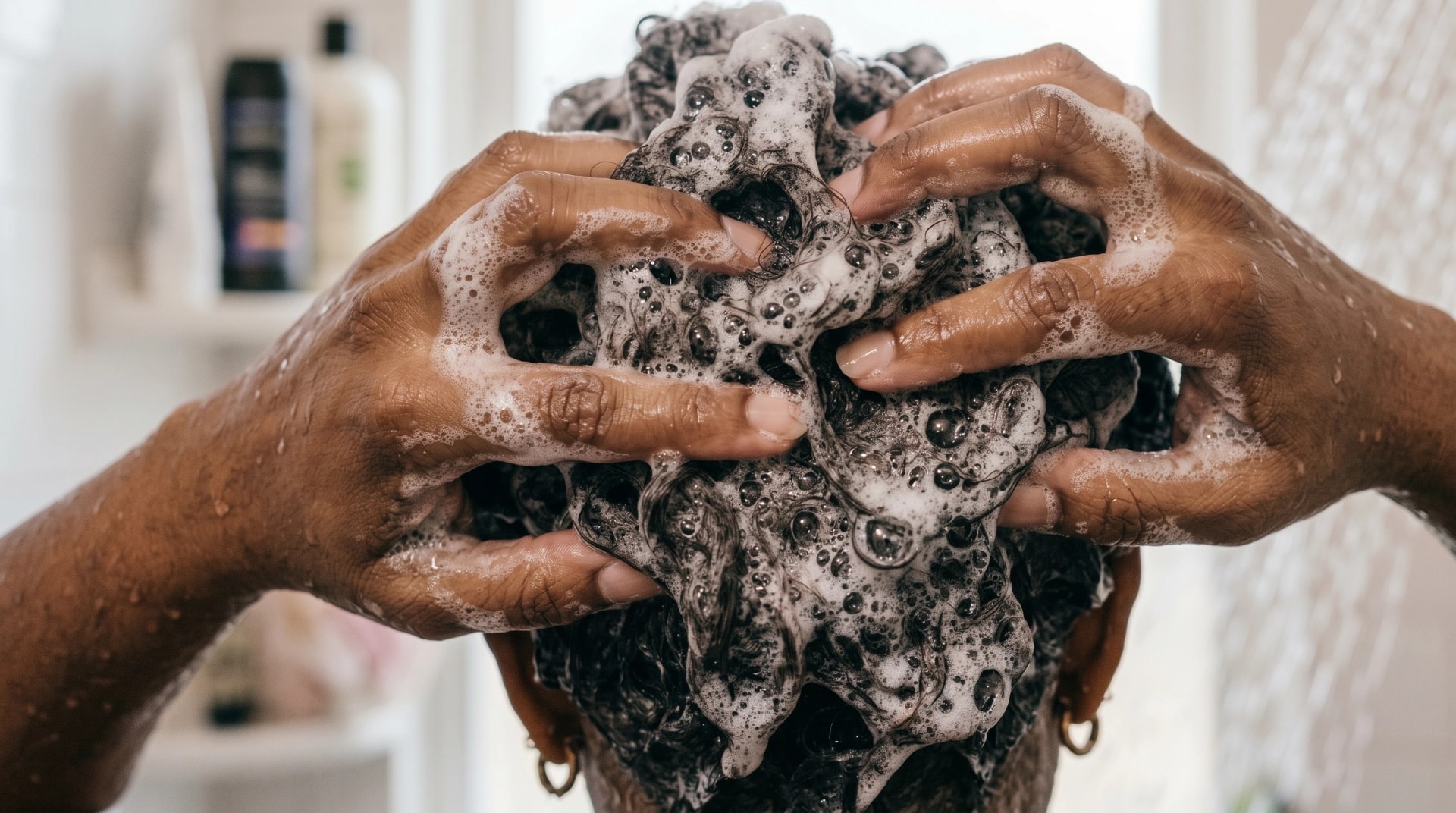 Close-up of hands working shampoo lather into the scalp