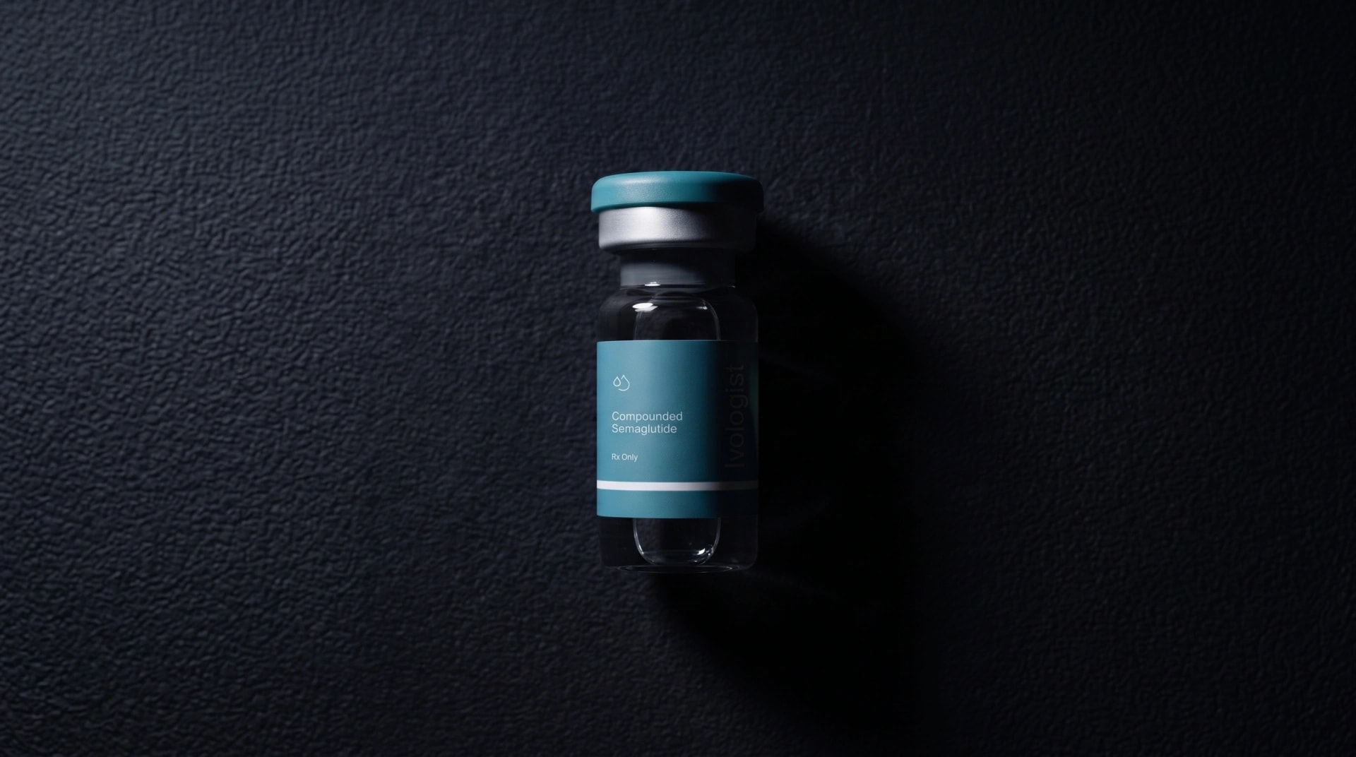 A single medication vial on a dark background
