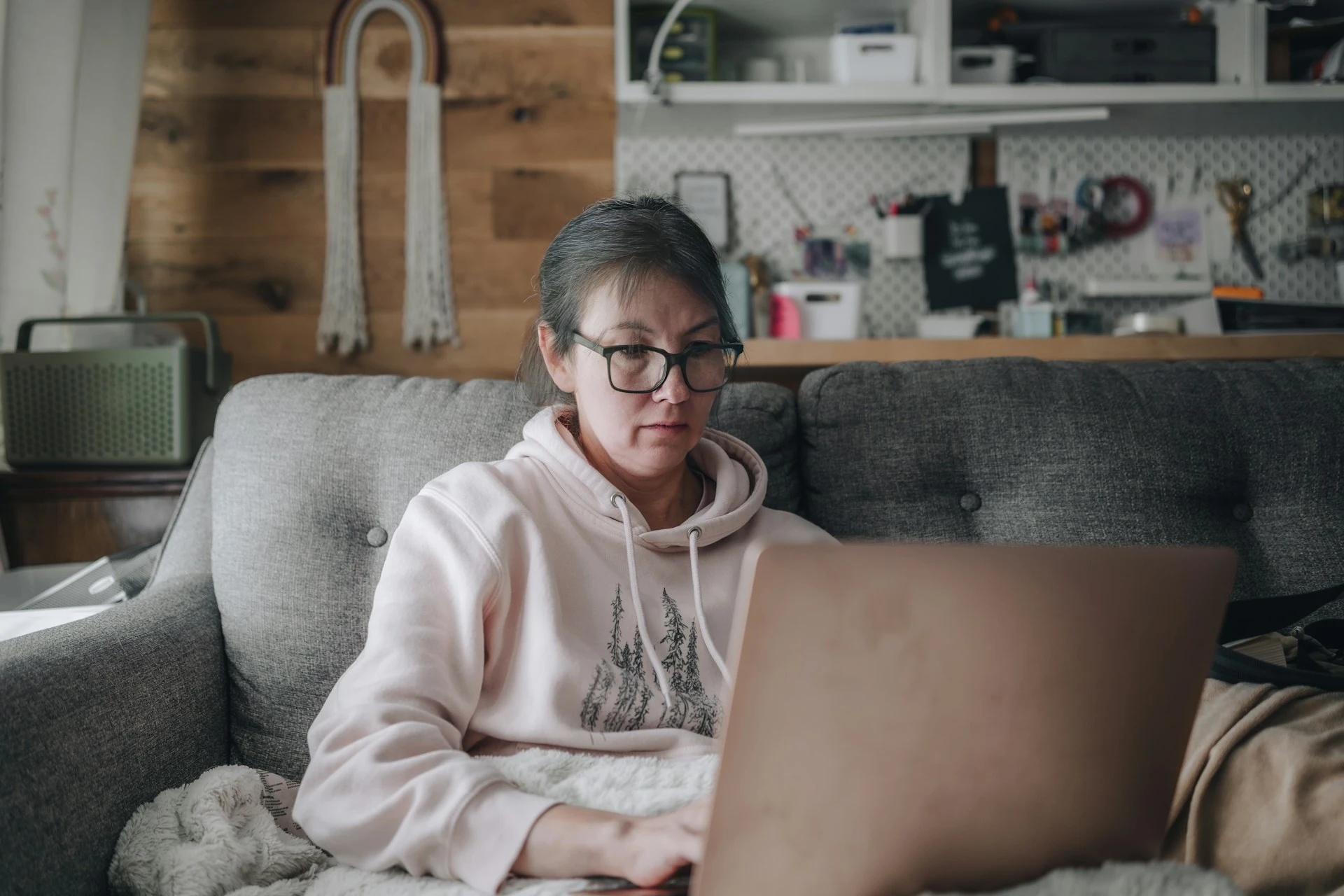 Woman researching weight loss injection costs on her laptop at home