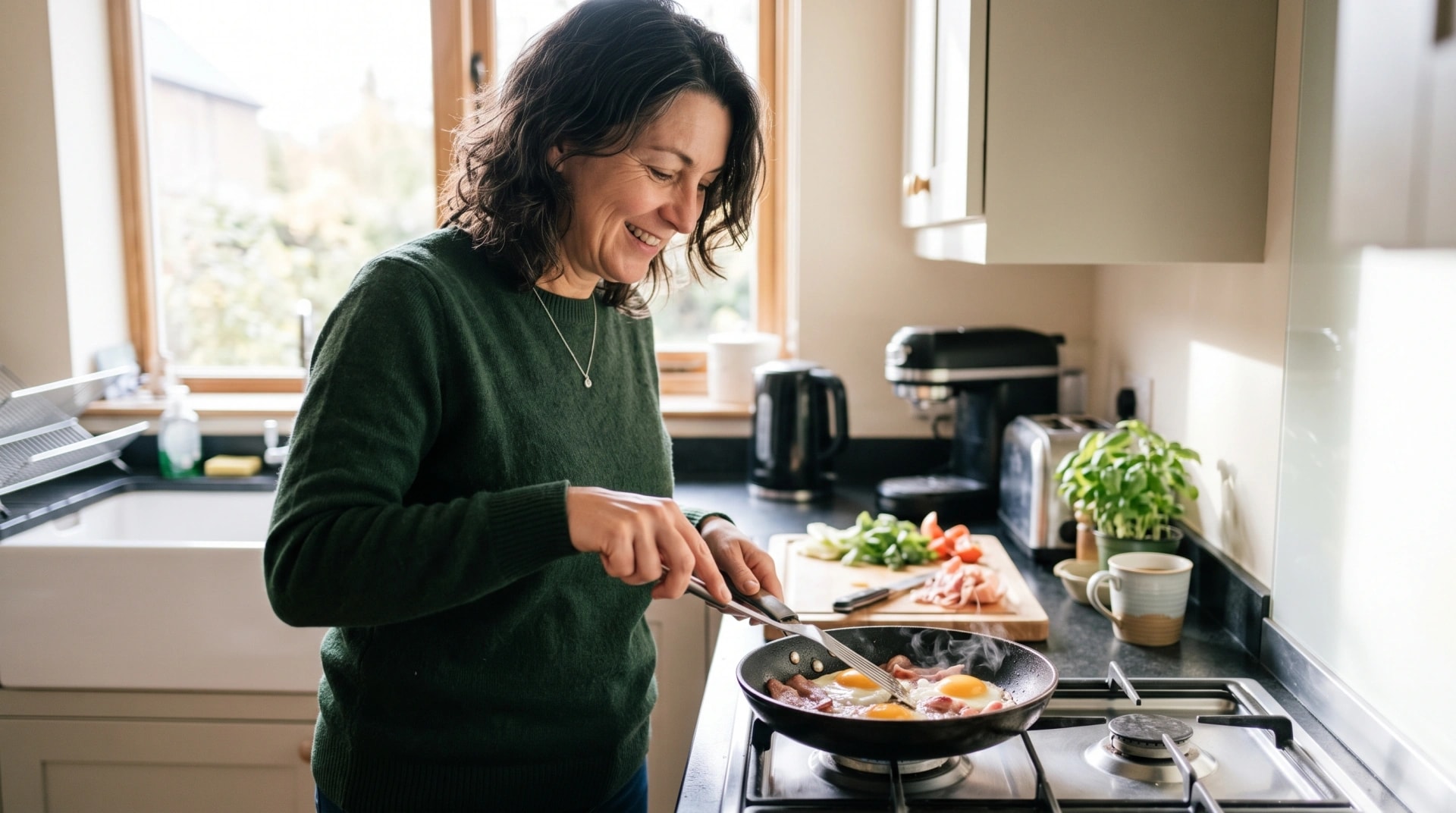 A woman smiling as she cooks a pan of chicken and vegetables in her kitchen